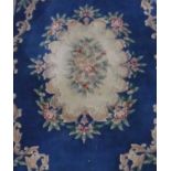 Chinese embossed washed woolen rug, blue ground with central medallion and floral patterned