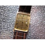 Avia quartz dress wristwatch with date 9ct gold rectangular case on brown lizard skin strap, snap on