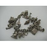 Sterling silver charm bracelet including car, bell keys, bananas, telephone etc stamped 925 2.47ozt