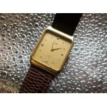 Grath Quartz wrist watch. 14ct gold case on brown leather strap. Brushed gold case with snap on back