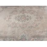 Chinese woollen cream ground rug, central floral medallion within a triple stripe, floral and scroll