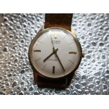 Accurist Shockmaster hand wound wrist watch. 9ct gold case on tan leather strap snap on bezel,