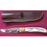 Harry Boden sheath knife with full tang and clip blade, two piece antler handle with brass front