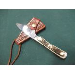 Small sheath knife with 2 1/4inch blade marked Ray Mears, two piece sambar horn grip and tooled