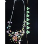 Dress necklace with floral center piece decorated with multicolored painted flowers and stones and