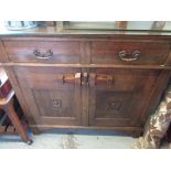 Arts and Crafts style oak sideboard, two cushion shaped drawers above two doors with rustic latch