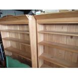 Pair of pine six tier alcove bookcases with panelled backs on plinth bases, W94cm D29cm H179cm (2)
