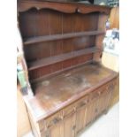 Old Charm oak dresser with twin shelf raised back above two drawers and panelled door, a set of four