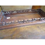 Japanese hardwood rectangular stand, with moulded top on scroll carved pierced frieze and angular