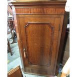 Early C19th mahogany cross banded golden oak corner cupboard, moulded door above three shaped