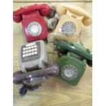 Three 1960s/70s GPO telephones in red, cream and green and a similar wall mounted push button
