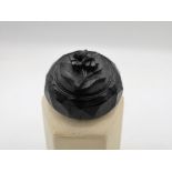 Whitby Jet carved brooch with central floral design D3.5cm