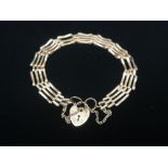 Hallmarked 9ct gold 4 bar gate bracelet with safety chain and heart padlock clasp stamped 375 6.