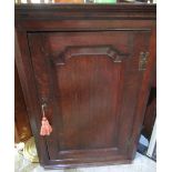 Geo.III oak corner cupboard, raised and fielded door with brass H handles and three shaped shelves