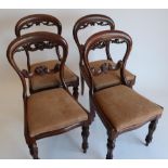 Set of four Victorian balloon back mahogany dining chairs, pierced and scroll carved splats and drop