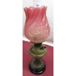 Early 20th Duplex brass paraffin lamp, with relief moulded and etched cranberry coloured shade,