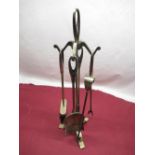 Four piece lacquered brass companion set on stand