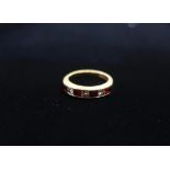 Hallmarked 18ct gold half hoop eternity ring set with princess cut diamond and ruby stamped 750,