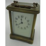 Early C20th French brass carriage time piece, gorge case with beveled glass panels, enamel dial