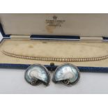 Graduated simulated pearl necklace with a Sterling silver fish hook clasp decorated with three