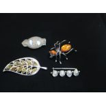 Collection of brooches including Spider with amber set in silver mount stamped 925, another in the