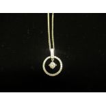 Hallmarked 9ct white gold diamond set circular pendant D1.5cm on a 9ct white gold curb chain