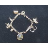 Hallmarked 9ct gold charm bracelet with marked and unmarked charms some stamped 9.375, 26.2g gross