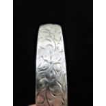 Hallmarked Sterling silver bright cut hinged bangle, another similar, and a Sterling silver bright