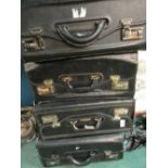 Four black leather flight type cases