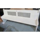 Large cream painted pew type bench seat with panelled back on shaped end supports W215cm D50cm H94cm