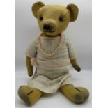 Merrythought c. 1930's teddy bear with glass eyes, jointed arms and legs, swivel head and label on