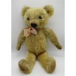 Circa 1930s Merrythought teddy bear in golden mohair with tag on foot, button in ear, glass eyes,