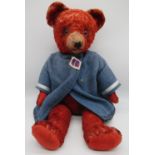 Circa 1930s artificial silk red teddy bear, possibly Deans, with light glass eyes, jointed arms