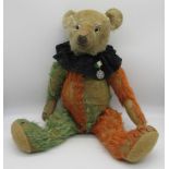 Unusual c. 1930s Jester teddy bear in green and red mohair with clear glass eyes, jointed arms and