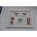 Framed and mounted display of German WWII medals and insignia (medals copies, insignia possible