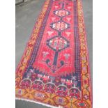 Red blue and gold ground Persian style runner rug with 3 central medallions 332cm x 119cm
