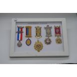 Framed and mounted display of Order of the Buffalo medals silver hallmarked Birmingham, 1932,