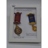 Framed and mounted silver gilt 1913 coronation Order of the Buffalo medal and another similar (2)