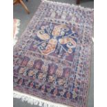 Blue ground Persian style rug with central pattern and repeating boarder 191cm x 119cm