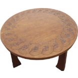 Thomas Gnomeman Whittaker - oak coffee table, circular top carved with strapwork on three angular