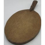 Robert Mouseman Thompson - oak oval cheeseboard, curved handle, carved with signature mouse, L28cm