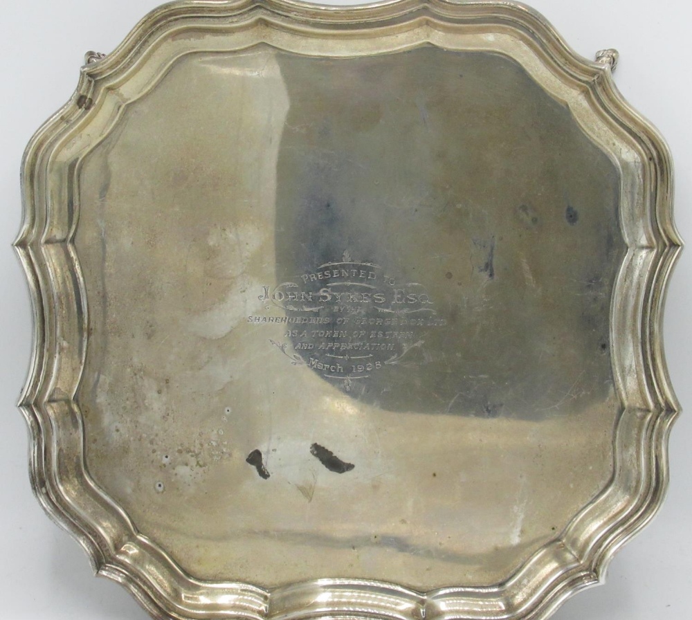 Geo.V hallmarked silver shaped square salver, with raised Chippendale style border on four scroll