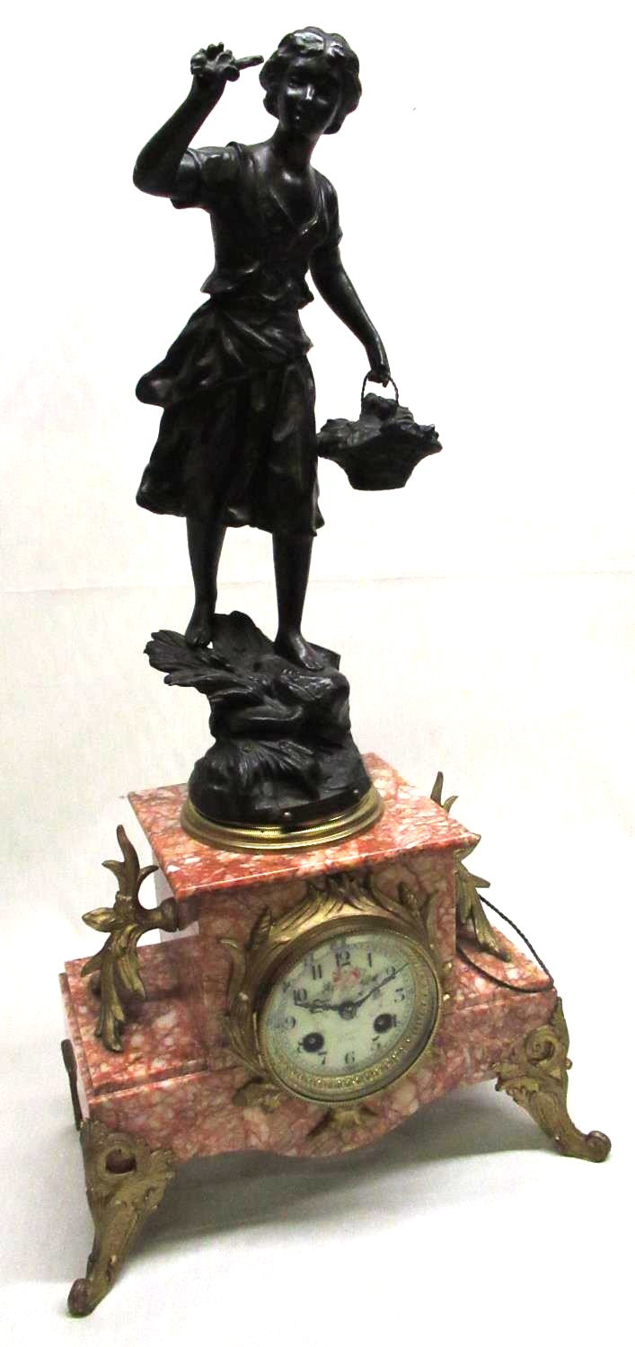 Early C20th gilt metal mounted salmon pink marble mantel clock, surmounted by a spelter model '