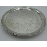 Geo.III hallmarked silver circular salver with beaded border three beaded scrolled feet, later