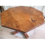 Bob Wrenman Hunter - an oak coffee table, burr octagonal top on leaf carved column support with X