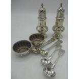 Pair of Victorian hallmarked silver baluster pepperettes with wrythen finials on stepped circular