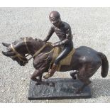 Large cast iron patinated as bronze model of a horse with jockey up, on naturalistic rectangular