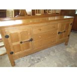 Robert Mouseman Thompson - oak sideboard, adzed top with raised back above three drawers with turned