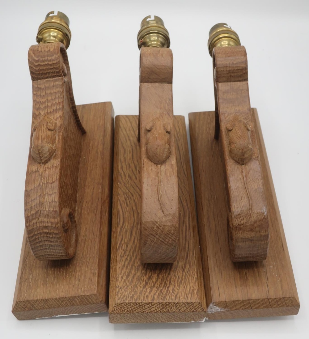 Robert Mouseman Thompson - set of three adzed oak wall lights with scroll carved detail and