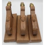 Robert Mouseman Thompson - set of three adzed oak wall lights with scroll carved detail and